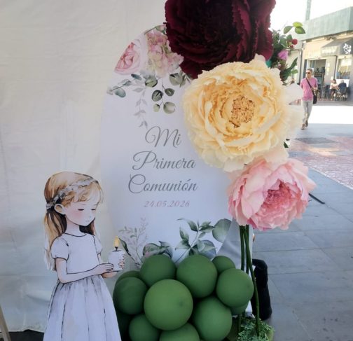 Decoración de primera comunión con flores gigantes y globos verdes